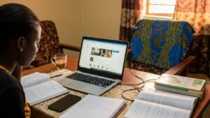 Home-based learner using laptop to break online degree myths Nigeria and apply with confidence
